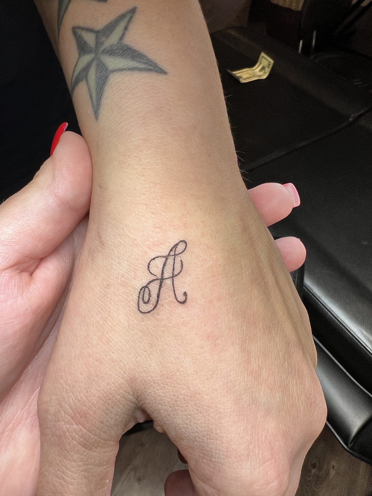 Mini tattoo — initial on the hand