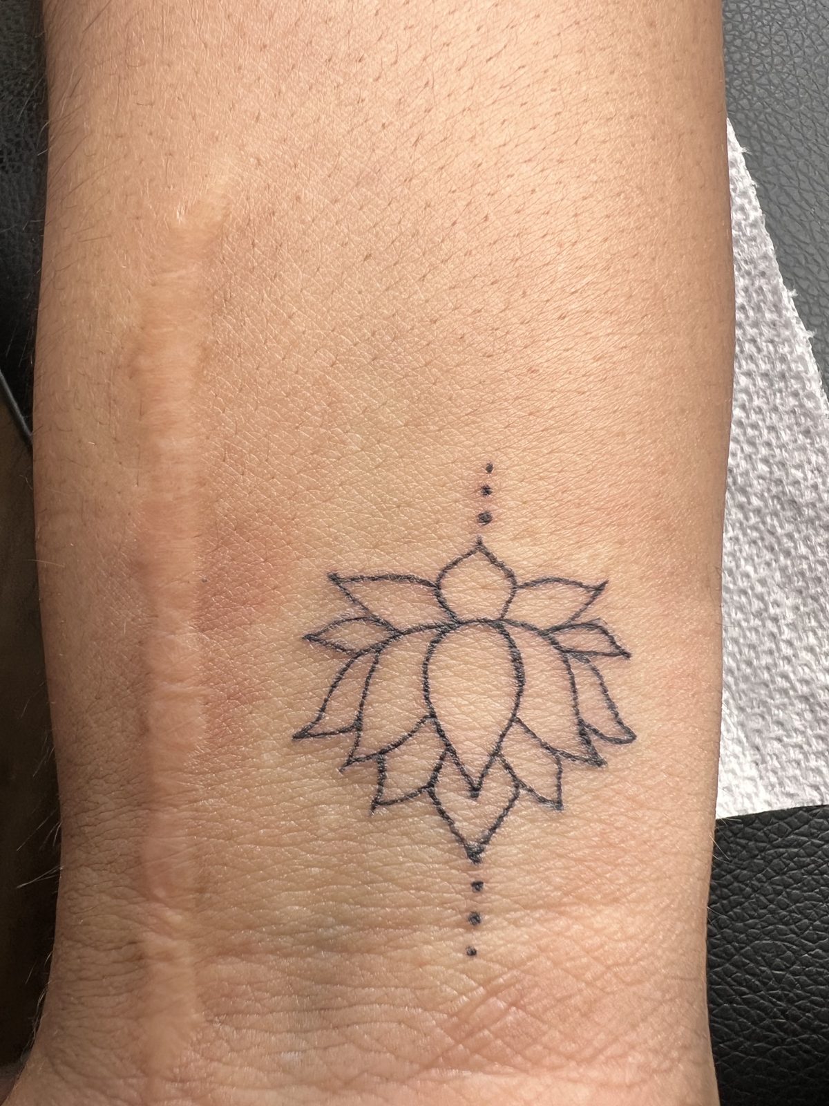 Mini tattoo — lotus design on the forearm
